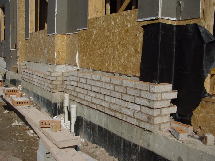 Siding over brick